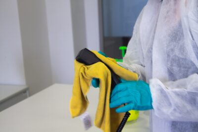 Cleaning work phone with microfiber cloth as part of Houston office cleaning services