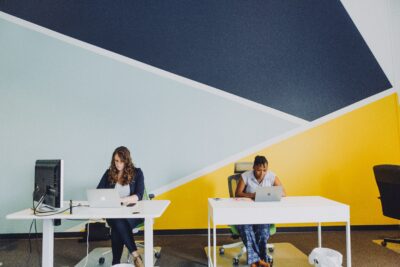 people at desks in hot desking or coworking office