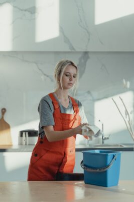 Woman providing Houston janitorial services in office break room