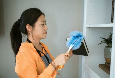 woman dusting for Houston office cleaning services
