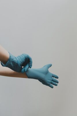 janitorial professional putting on gloves for Houston office cleaning