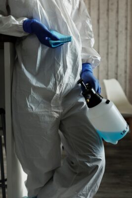 person with disinfectant and rag for Houston janitorial services for bank branch