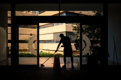 Houston janitorial services crew member mopping floor in commercial building