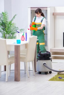 Person performing Houston office cleaning services in a break room