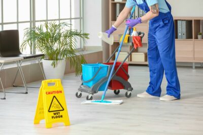 Person performing Houston commercial cleaning services inside an office. 