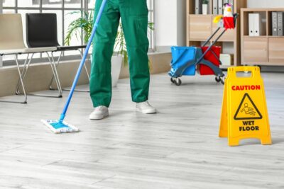 Person providing janitorial services to modern office building