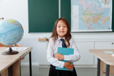 Girl in private school standing in classroom that had deep clean from Houston building cleaning service